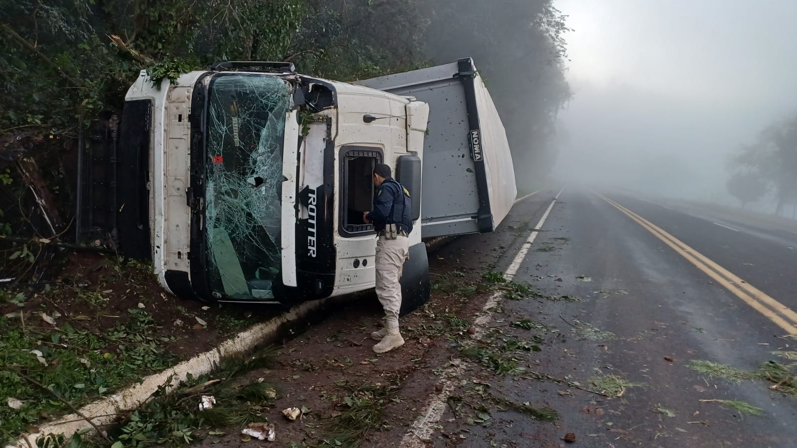 Caminhão tomba em meio à neblina intensa